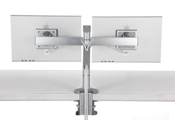 A photo of the Humanscale M8.1 Radial Monitor Arm with Dual Monitor Crossbar attached to a desk, showing two monitors side-by-side.
