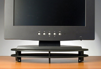 A graphite and black flat-screen monitor stand with interlocking stacking trays and storage space for small items.